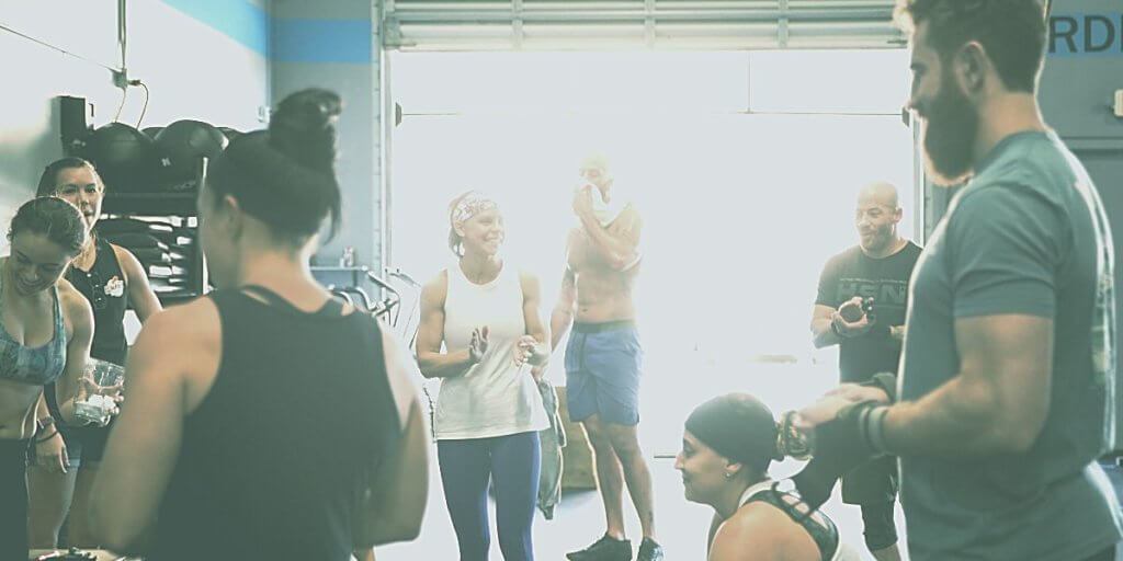 engagement strategies of a group crossfit class listening to coach
