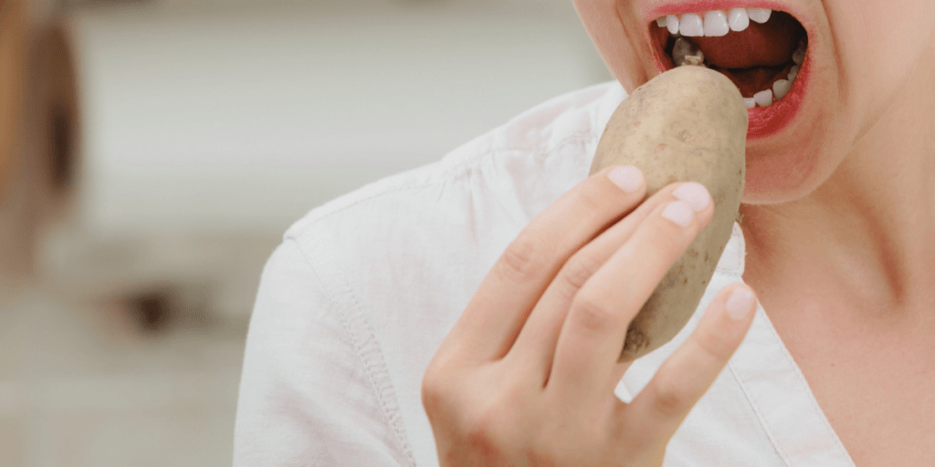woman eating a whole potato mocking fad diets