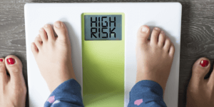 kids feet on scale showing high risk for obesity needing nutrition for teens