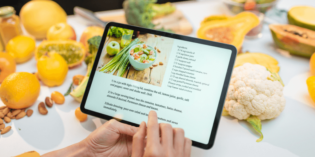 person typing on ipad looking at a healthy recipe